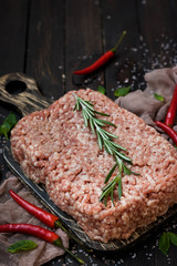 Raw meat with fresh herbs and pink Himalayan salt