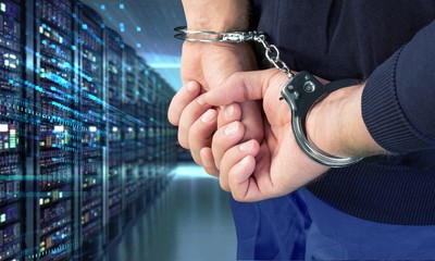 Cropped image of male hands in handcuffs