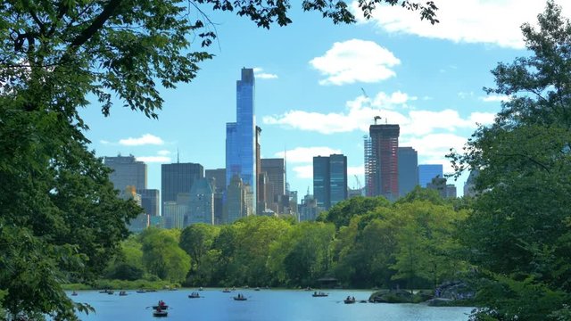 4K (UHD) 25P New Yor City, Central Park - Oak Bridge view on the pond and city skyline