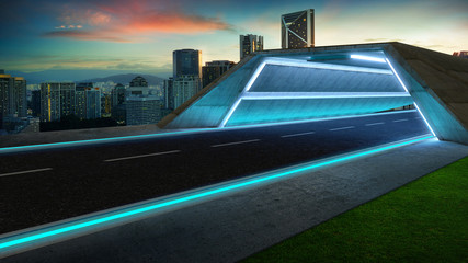 Futuristic style highway tunnel road with blue neon light and cityscape background .