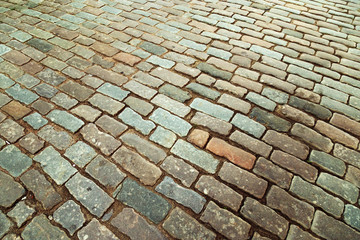 Cobblestone road. Big stones on ground close up. Road surface. Top view. Selective focus