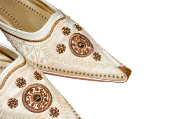 Arab women's white shoes made of natural silk embroidered with curled toes on isolated background.  