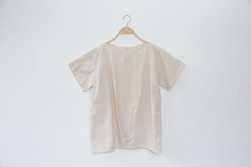 Natural linen fabric blouse is clothes hanger on white background.close up.
