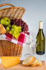 Picnic Basket And Wine With Cheese And Bread Close-up