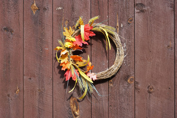 autumn wreath hanging on the old wood door