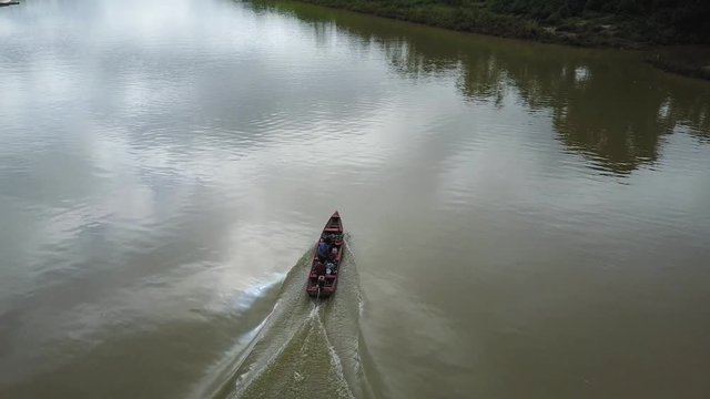 A speed boat sailing on a river in a Brazillian village Nova Morada, Drone shot
