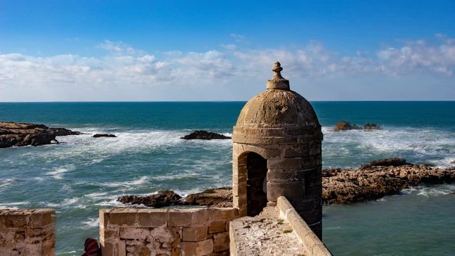Cinemagraph of a fortress outpost at Essouira Morocco with the water and clouds moving.