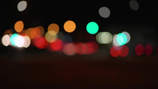 Moving city bokeh lights from traffic for green screen or chrome key. Out of focus or defocused shot for compositing or keying. 
