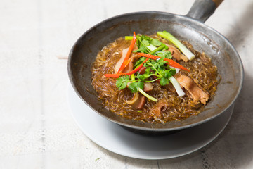 casserole becon with glass noodles in pan on white table