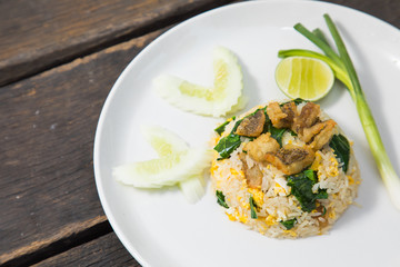 Fried rice with Fried Fish on the wooden table from top view