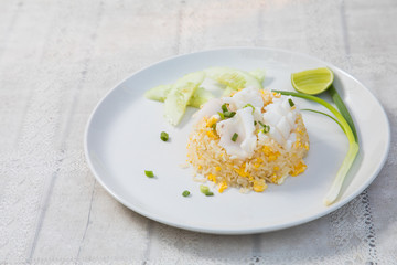 Fried rice with Squid on the wooden table from top view