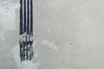 black tire track on dirty concrete after sudden brake