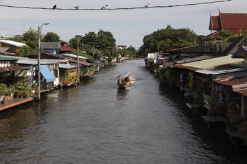 Fototapeta na wymiar A motorboat is sailing in a canal in Bangkok, the capital of Thailand