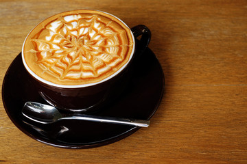Cup of coffee on wooden background