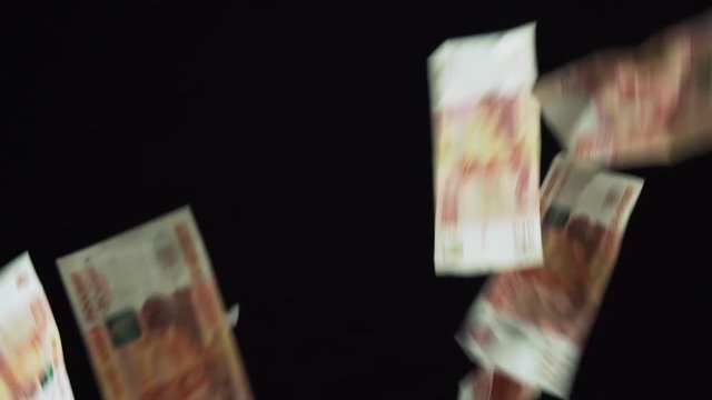Banknotes five thousand rubles fall on black background slow motion stock footage video
