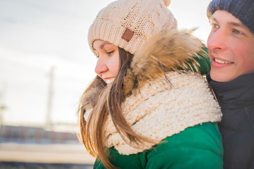 Portrait of happy couple hugging outdoors in a winter day