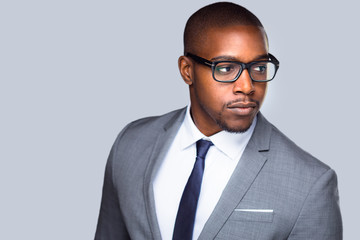 Close up candid, swanky, stylish, handsome, businessman, executive, modern glasses isolated on grey