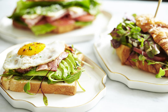 Bacon and avocado toast with croissant sandwich 
