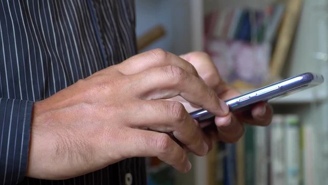 modern mobile phone in the hands of a man close up.