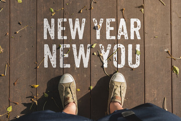 Aerail view of New year new you word on wooden plank floor with people foot wear canvas shoe standing.goal resolutions for life.