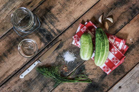 overhead flat lay image of cucumbers and ingredients to make refrigerator pickles