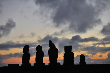 Easter Island. Statues of moai on the shore of the Pacific Ocean in the evening.