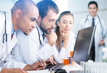 Female and male scientists in glasses working