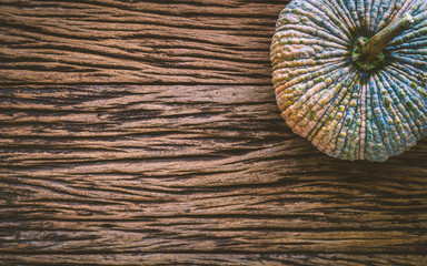 Top View of raw pumpkin on gruge wooden background. Fresh organic vegetable, top view with copy space.