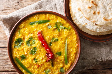 Spicy Indian thick soup Dal Tadka is a popular North Indian recipe close up in a bowl. horizontal top view