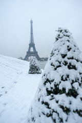 Eiffel tower under the snow in winter in Paris