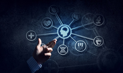 Close of businessman hand showing at user interface glowing on wall