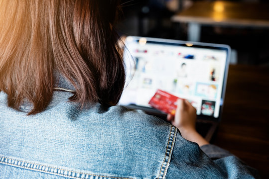 Black Friday, Beautiful woman using credit card and laptop for shopping online.