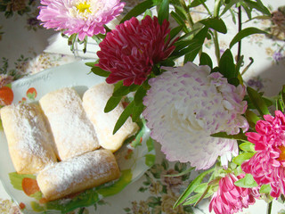 Pink asters and cakes on the plate