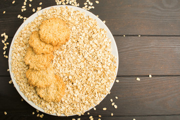 Big plate with dry oat with homemade cookies on it