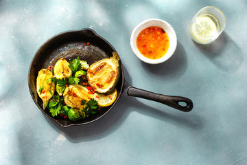 Vegetarian healthy dinner table Fried brussels sprouts zucchini frying pan top view