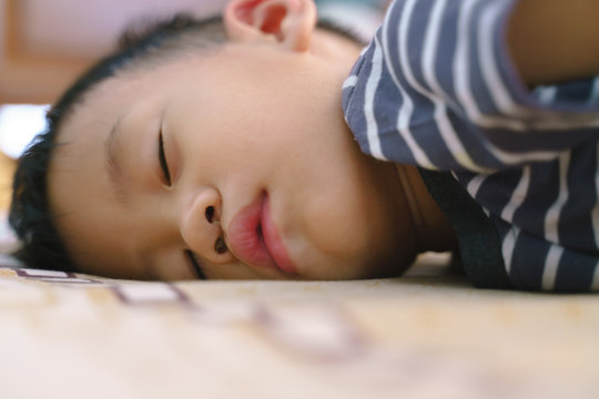 Sleeping Asian baby with stuffy nose.