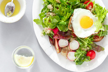 healthy breakfast summer salad fried egg gray concrete background top view