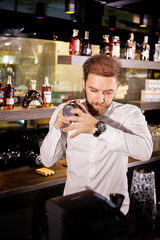Alcohol cocktail on the bar. Bartender prepares an alcoholic cocktail . Delicious drink