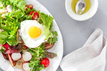 healthy breakfast summer salad fried egg gray concrete background top view