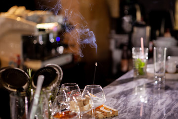 Aromatic smoke sticks on bar counter.