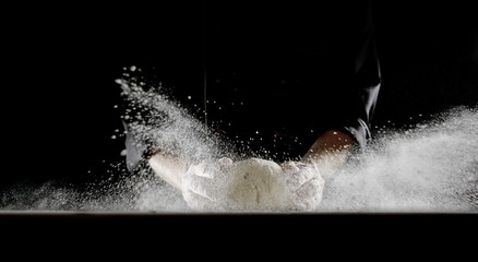 Frontal view of man dropping dough onto table