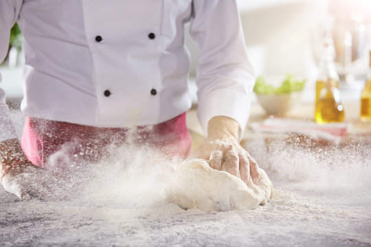 Chef In White Suit Rolling Ball Of Dough