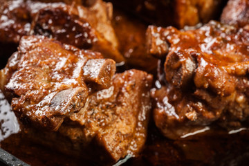 Pork spare ribs on dish in own sauce