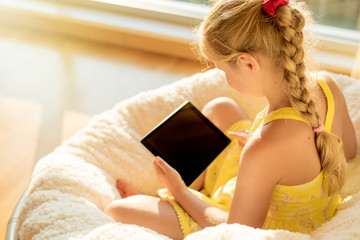 Girl using tablet computer at home © Kaspars Grinvalds