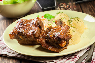 Pork spare ribs served with mashed potatoes and sauce