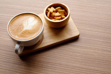 Coffee in white cup on wood table