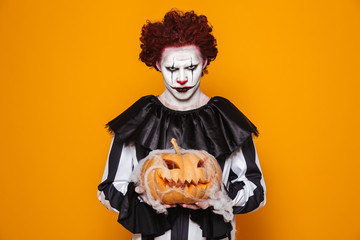 Angry man dressed in scary clown Halloween costume