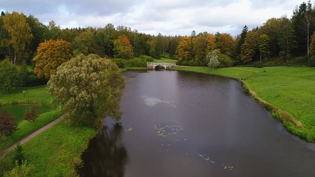 Flight over the river Slavyanka, cloudy September day. Pavlovsk, St. Petersburg, Russia (aerial video)