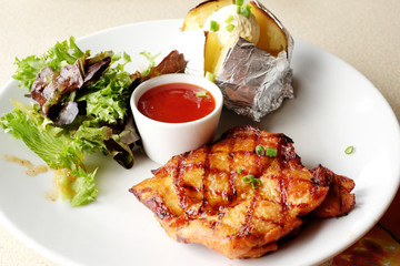 Grilled chicken, baked potatoes and chili sauce