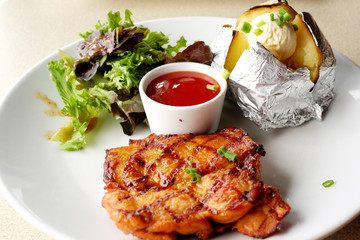 Grilled chicken, baked potatoes and chili sauce